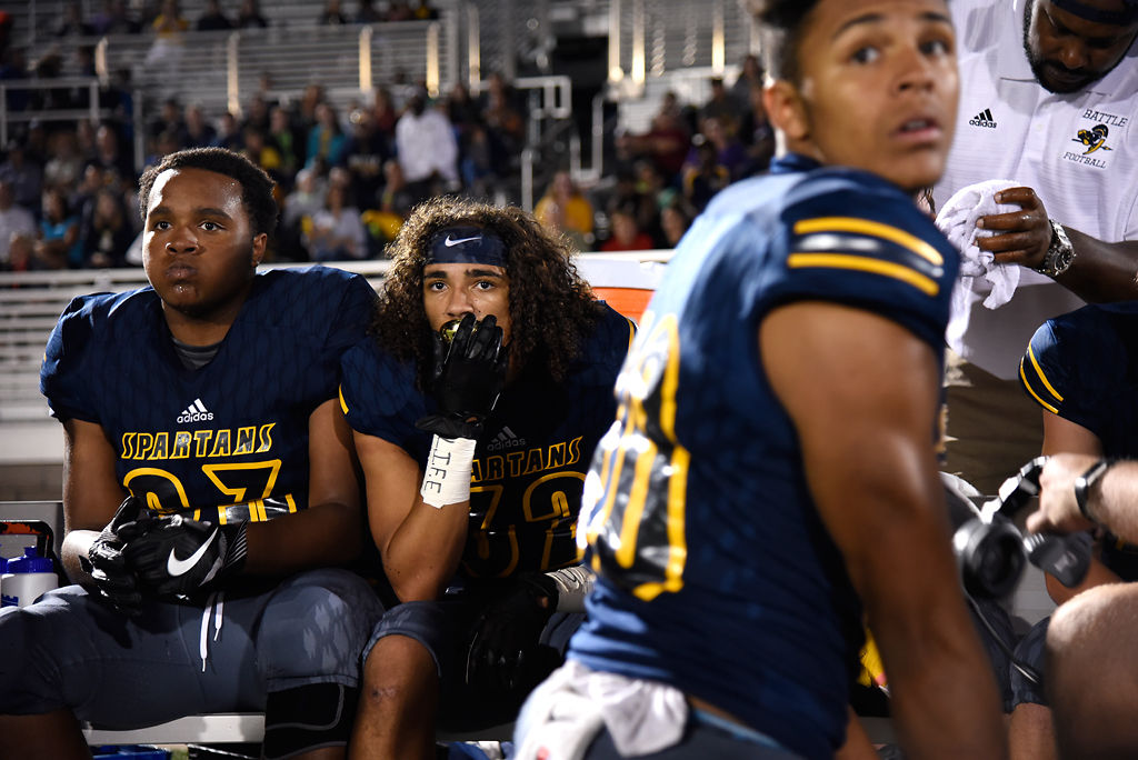 Muriel Battle High School football players Keesean Payne, left, Trevonne Hicks and Isaak Smith, right, watch as their defense intercepts the ball